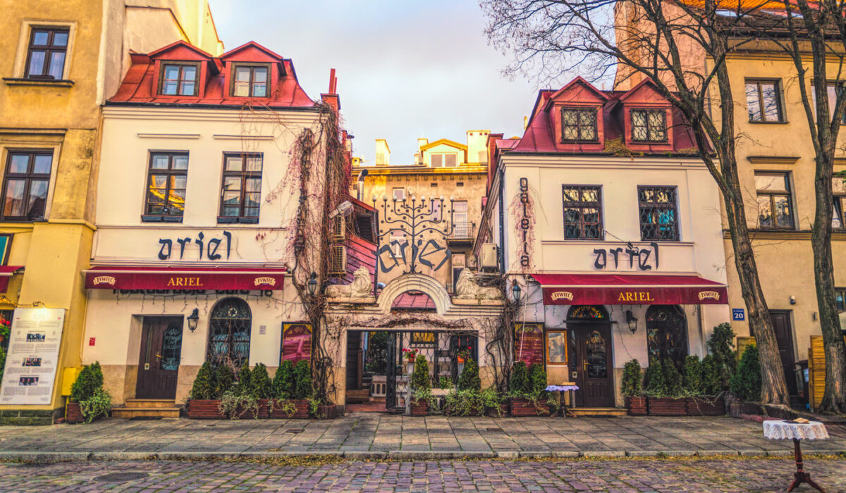 Krakow tour electric car passing the Main Market Square with St. Mary’s Basilica in the background